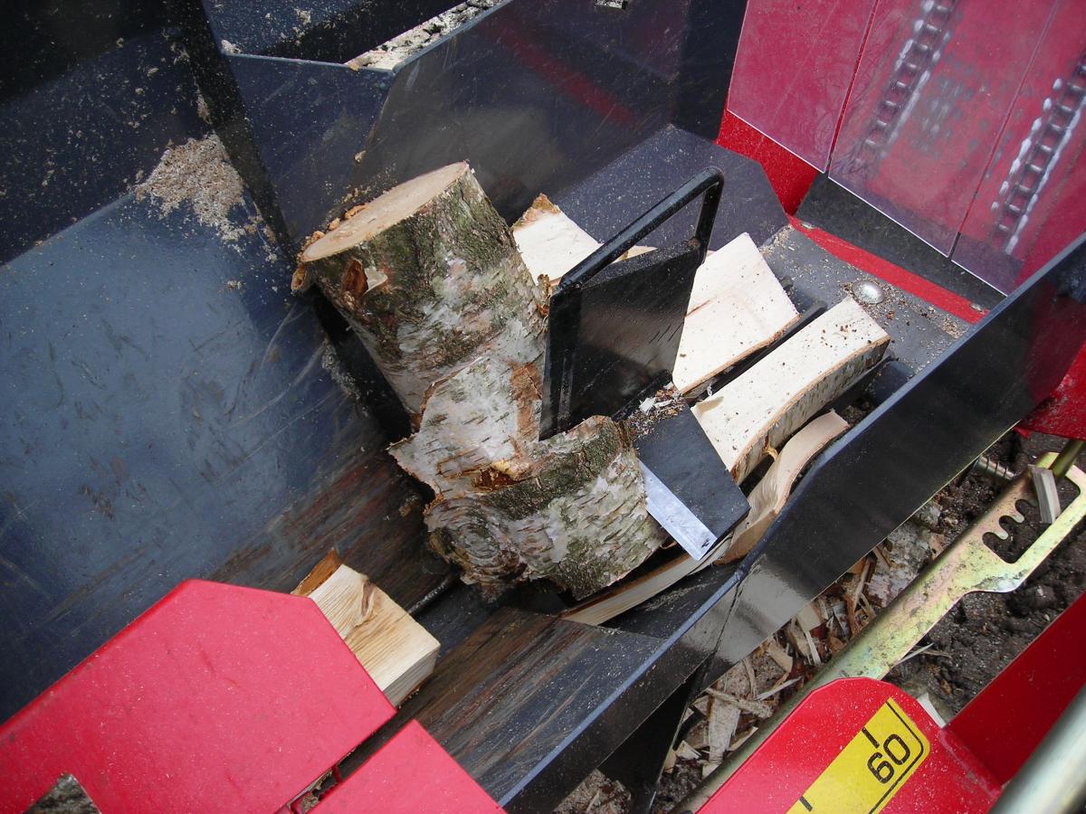 Wood splitting machine creating logs